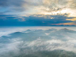 Wall Mural - Aerial view of mountain and morning mist during sunrise.
