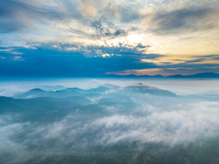 Wall Mural - Aerial view of mountain and morning mist during sunrise.