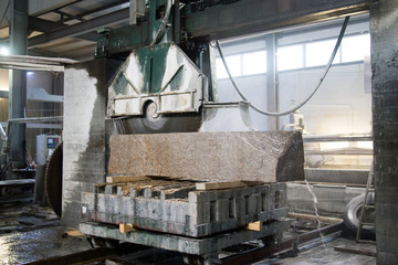 Wall Mural - Granite processing in manufacturing. Cutting granite slab with a circular saw. Use of water for cooling. Industrial sawing of granite