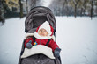 Baby girl in stroller in Paris on a day with heavy snow