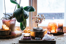Feng Shui Nature Theme Altar At Home Table And On Window Sill. Earth Element( Rock Crystal Clusters), Wood Element( Wood Discs), Fire Element( Candles), Rock Salt Candle Holder. Positive Home Energy.