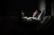 © karrastock - Man using his phone in his bed instead of sleeping, technology addiction concept