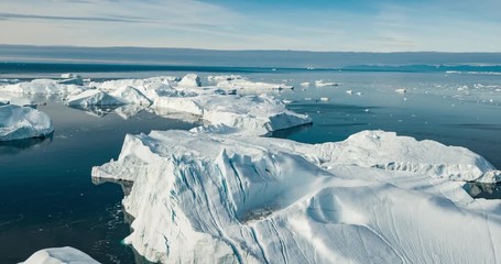 Wall Mural - Iceberg aerial drone video - Global warming and climate change concept. Giant icebergs in Disko Bay on greenland in Ilulissat icefjord from melting glacier Sermeq Kujalleq Glacier, Jakobhavns Glacier.