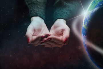 Poster - Protect our world in woman hands and nebula dust. Mixed media .Elements of this image furnished by NASA.