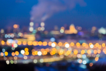 Wall Mural - Defocused abstract image. Bokeh effect. Golden lights of the big city. Night city landscape, lights and Windows of houses.