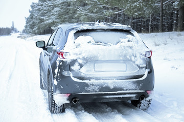 Snowy country road with car on winter day