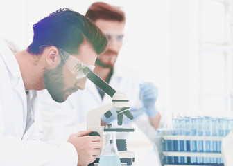 Wall Mural - biologist explores the substance under the microscope