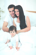 © ASDF - Cute little boy with parents on the bed