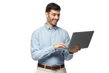 Young businessman using laptop, laughing, standing and smiling, isolated on white background