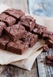 Pieces of freshly baked chocolate brownie on rustic wooden board