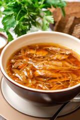 Wall Mural - Traditional Russian sauerkraut soup Shchi in bowl on rustic wooden background. Selective focus.