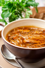 Wall Mural - Traditional Russian sauerkraut soup Shchi in bowl on rustic wooden background. Selective focus.