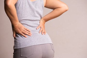 Close up woman having pain in injured back. Healthcare and back pain concept.