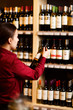 Photo from back of young woman at wine store