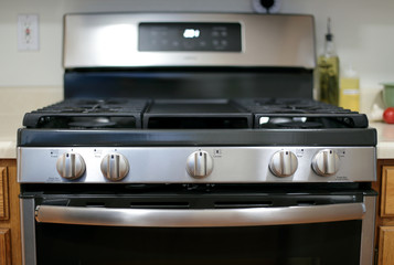 Modern stainless steel gas stove oven in a home.