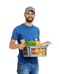 Canvas Print - Man holding basket with fresh products on white background. Food delivery service