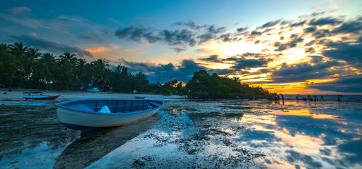 Wall Mural - Wooden boat with sunset background