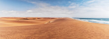 Panoramic Photograph Of Dunes And Ocean On Namibe Desert. Africa. Angola.
