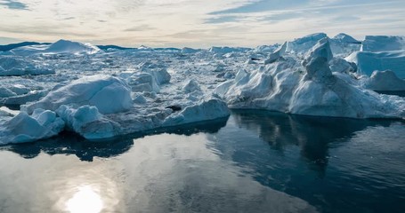 Wall Mural - drone video of iceberg and ice from glacier in arctic nature landscape on greenland. aerial video dr