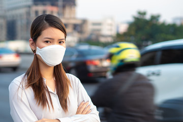 City air pollution concept. Close up woman wearing N95 mask to protect pm2.5 air pollution in city