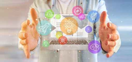 Poster - businessman holding a cloud of colorfull start up icon bubble with a laptop 3d rendering