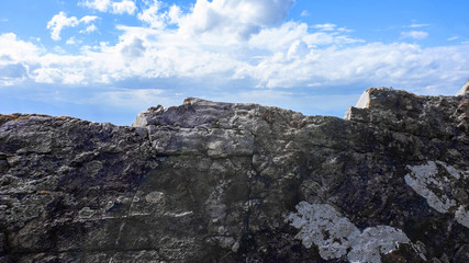 Wall Mural - Big heavy of rock stone with blue sky background ,Natural.