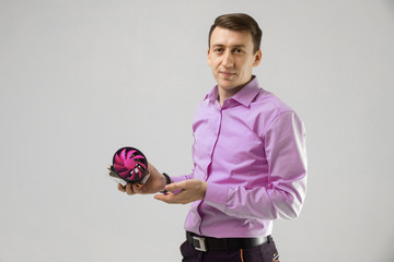 young man with a cooler from computer in his hands isolated on a light background