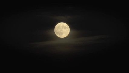 full moon in night sky surrounded by scary clouds and dark black sky