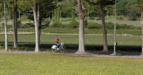 Sticker - Woman ride a bike in the countryside