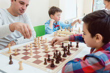 People In Chess School Learning The Game