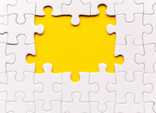 Copy Space Of Unfinished White Jigsaw Puzzle Pieces. One Missing Jigsaw Piece On Yellow Background