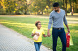 © littlewolf1989 - Happy family holding hands and walking together in the park. Happy lifestyle.