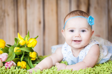 Wall Mural - Adorable baby girl with tulips