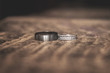 silver wedding rings on wooden table