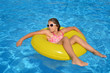 © SuperCoolPhotography - Real adorable girl relaxing in swimming pool