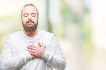 Sticker - Young caucasian hipster man wearing sport clothes over isolated background smiling with hands on chest with closed eyes and grateful gesture on face. Health concept.