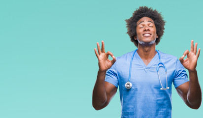 Sticker - Afro american surgeon doctor man over isolated background relax and smiling with eyes closed doing meditation gesture with fingers. Yoga concept.