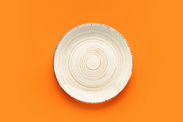 Stylish plate on color background