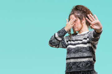 Sticker - Beautiful brunette curly hair young girl wearing glasses over isolated background covering eyes with hands and doing stop gesture with sad and fear expression. Embarrassed and negative concept.