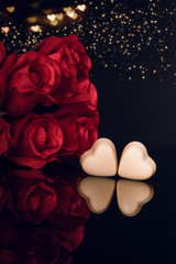 Wall Mural - Red roses and heart shaped chocolate on black background