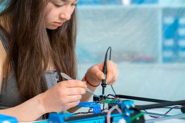 Wall Mural - Schoolgirl in the classroom design and development of robots