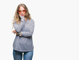 Sticker - Beautiful young blonde woman wearing sunglasses over isolated background thinking looking tired and bored with depression problems with crossed arms.