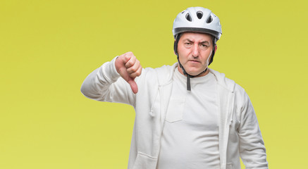 Sticker - Handsome senior cyclist man wearing bike helmet over isolated background with angry face, negative sign showing dislike with thumbs down, rejection concept