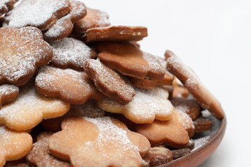 Original cookie flowers dusted with icing sugar on a white background isolated