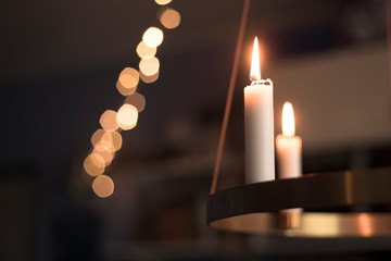 Candles glowing on advent chandelier.