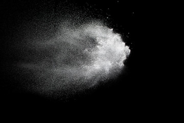 Wall Mural - bizarre forms of white powder explosion cloud against black background.white dust particles splash.