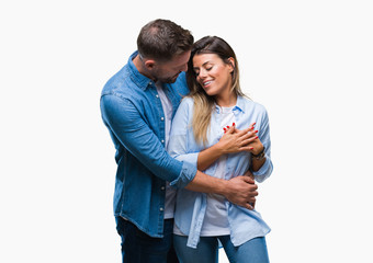 Sticker - Young couple in love over isolated background smiling with hands on chest with closed eyes and grateful gesture on face. Health concept.