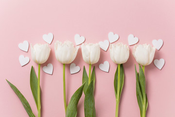 Wall Mural - White flowers and hearts on a pastel pink background