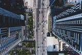 Aerial view of city asphalt road with lot of vehicles or car traffic and buildings, modern urban intersections and junctions in midtown