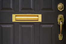 Close Up Outdoor View Of Part Of Door. Yellow Handle And And Mailbox. Mailbox Slot Incorporated. Abstract Object Image.